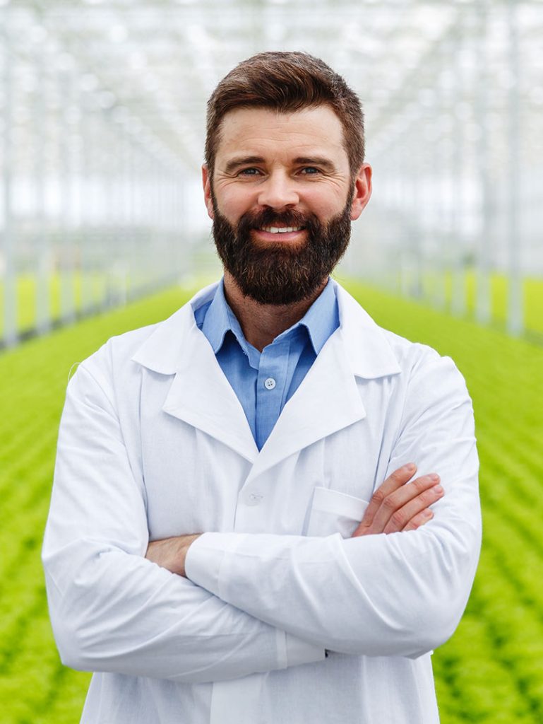 man standing in greenhouse